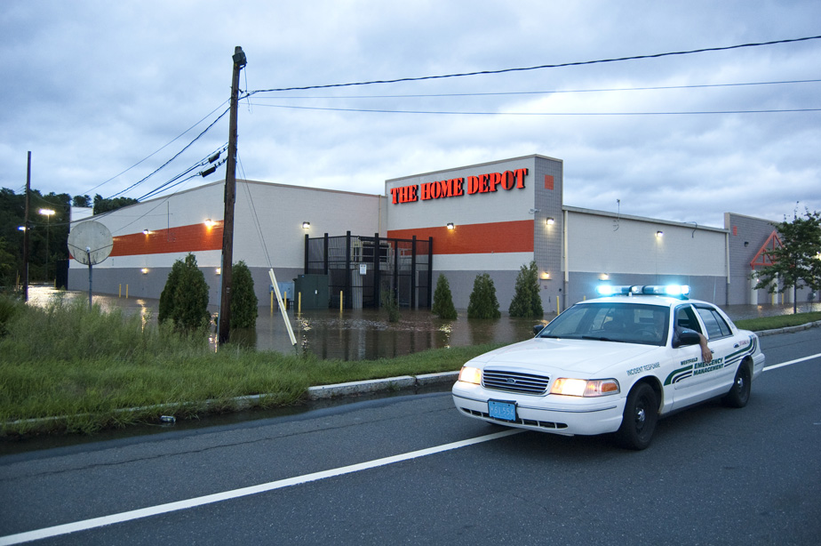 Emergeny vehicle in front of a flooded building.