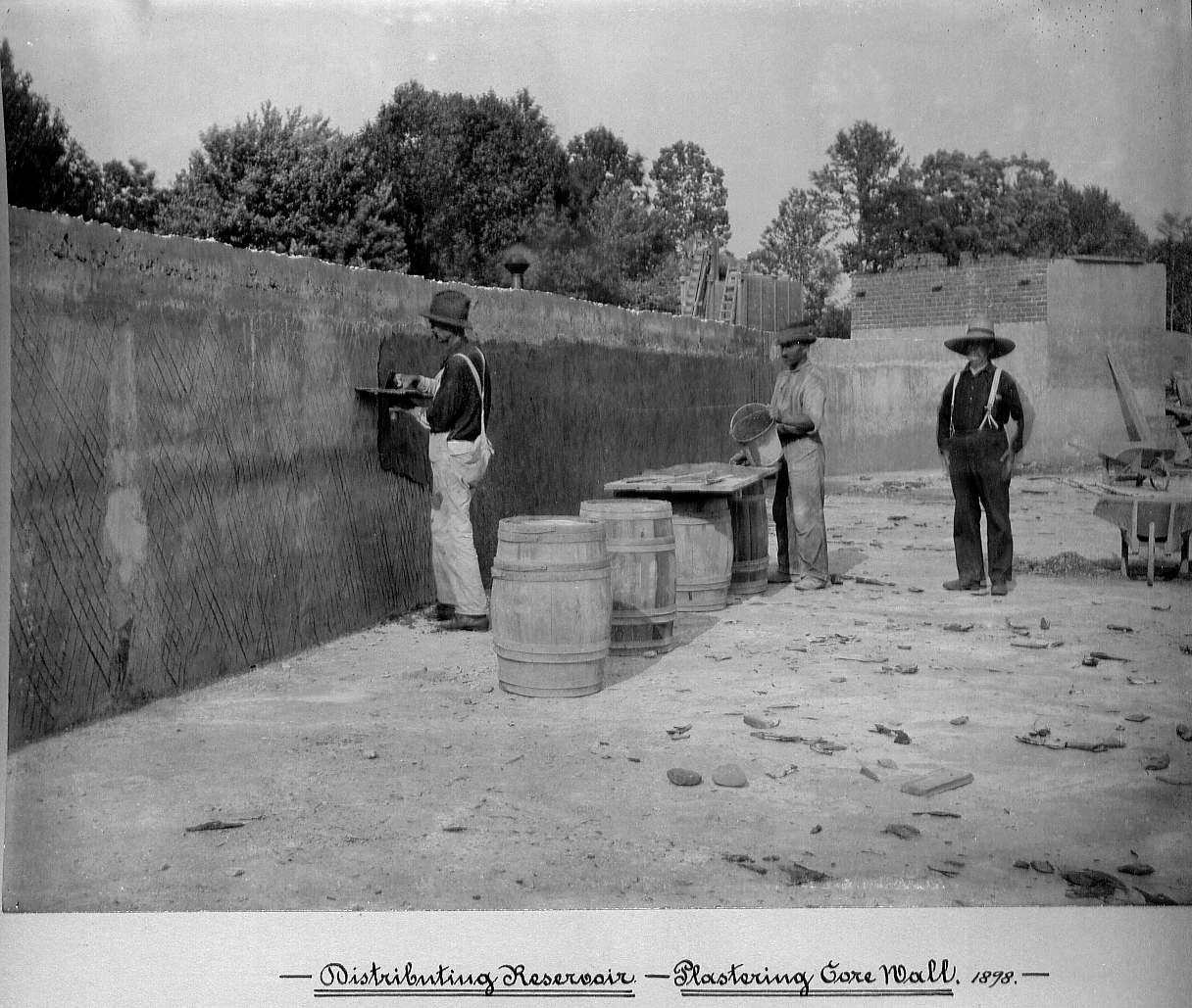 Men applying plaster to the core wall