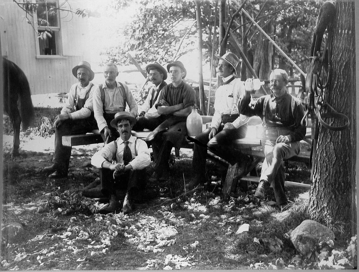 Men sitting on benches celebrating